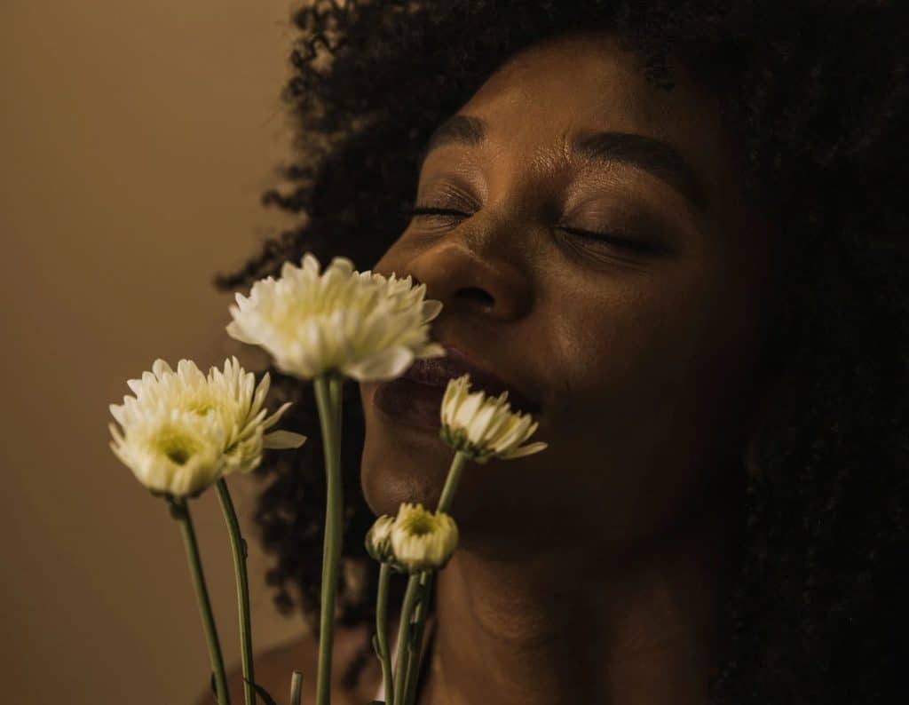 girl smelling flowers